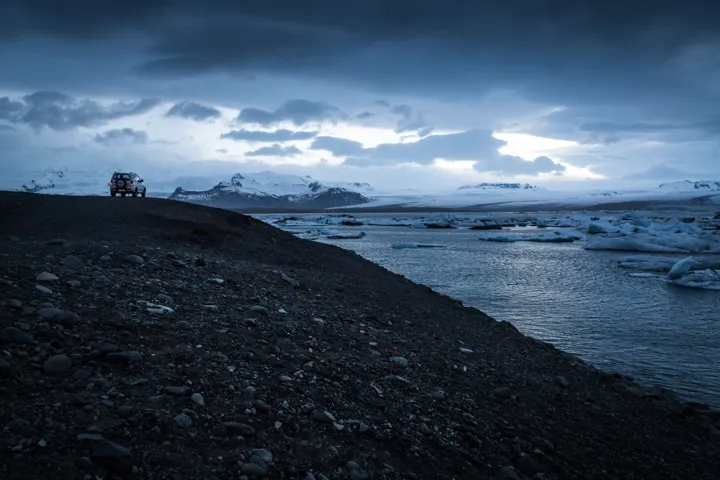 A dramatic Icelandic shoreline beneath dark clouds.